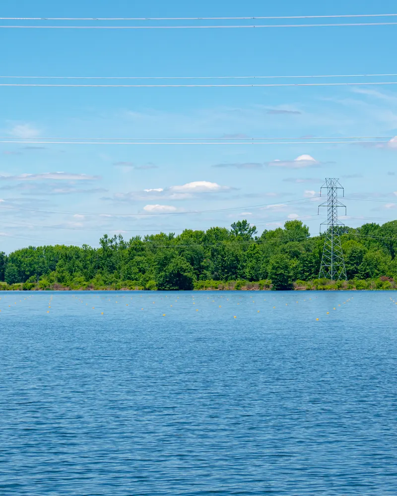 Lake shoreline with transmission towers and power lines